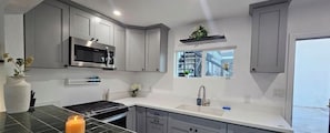 Coffee/tea maker, fridge, microwave, oven
