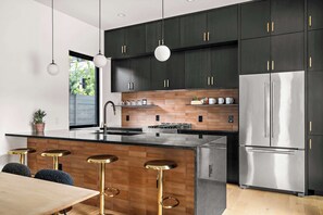 Enjoy cooking in this well-lit kitchen with a central island and bar stools.