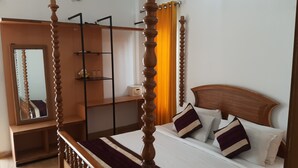 A four-poster bed with a wooden headboard, a bedside table, and a mirror. - KOSHA RESORT (Meerut)