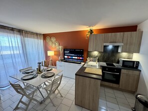 Enjoy a meal at the kitchen table, with a stove and microwave at your fingertips.