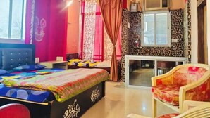 A room with a bed, a chair, a desk, and a window. - Shree Radha Residency-near ISKCON Temple (Vrindavan)