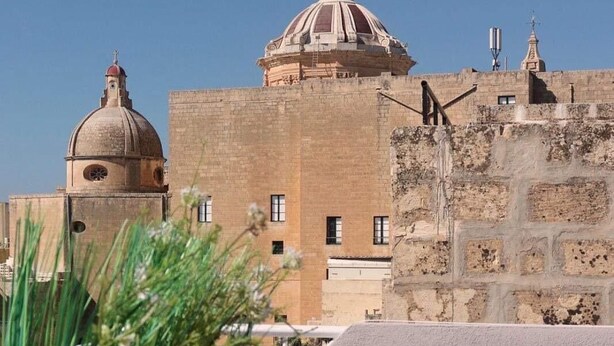 A building with a dome and a smaller tower, surrounded by greenery and a clear sky. - Tranquil studio with AC in Rabat - Studio No.2  (Rabat)