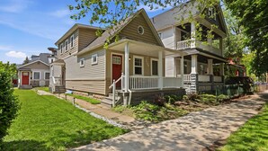 A row of single-story houses with front porches and a well-maintained lawn. - Coffee Lover's Paradise - Heart of Tremont (Cleveland)
