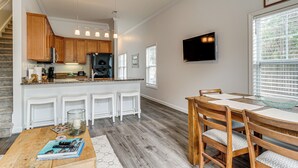 A modern kitchen with wooden cabinets, a built-in island, and pendant lighting. - 4 Mi to Ocean: Modern Townhome in Wilmington! (Wilmington)