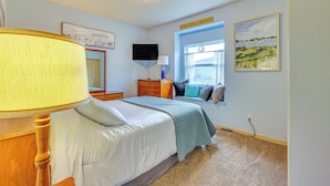 A bedroom with a bed, a window with a view, a television, and a sign on the wall. - Hidden Gem in the Heart of Old Town Meridian (Meridian)