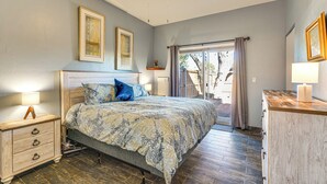 A bedroom with a bed, nightstands, a dresser, and a ceiling fan. - 12 Mi to Dtwn Tucson: Tranquil Townhome w/ Office (Tucson)