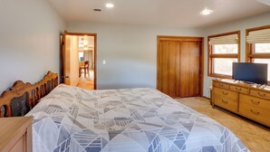 A bedroom with a bed, wooden wardrobe, dresser, and a television. - Near Hiking: Mtn-view Getaway in Bayfield! (Bayfield)