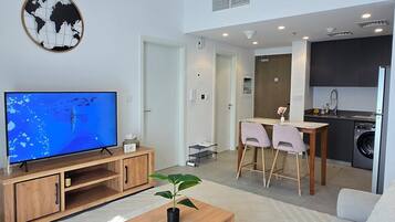 Exclusive Apartment, Balcony, Pool View | Living area | Flat-screen TV