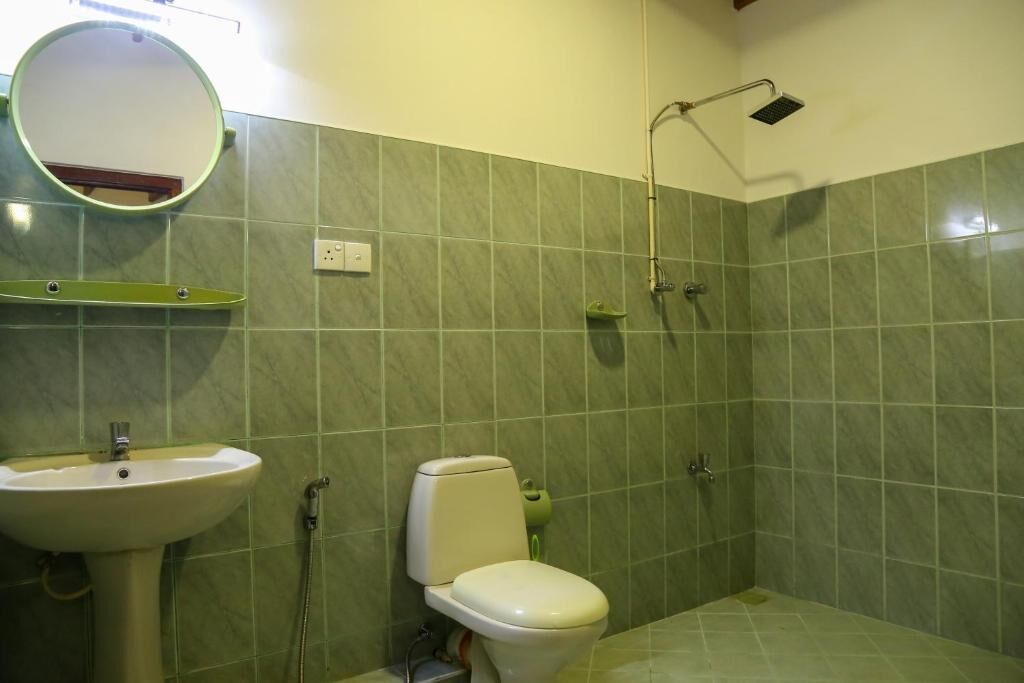 A bathroom with a sink, toilet, and shower.