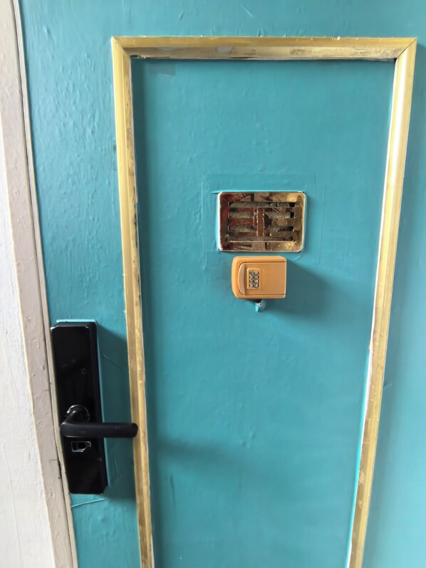 A door with a blue frame, a keyhole, and a lock.