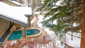 A residential area with a swimming pool, a hot tub, and a snow-covered yard. - Beaver Creek Townhome w/ Amenities | RP187 Stays limited to a max of 14 nites (Beaver Creek)