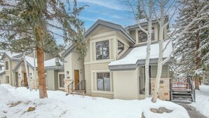 A two-story house with a snow-covered roof and a visible front door. - Beaver Creek Townhome w/ Amenities | RP187 Stays limited to a max of 14 nites (Beaver Creek)