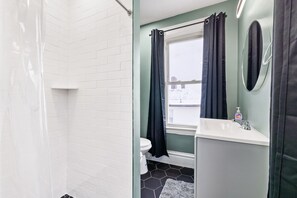 Shower, hair dryer, towels, toilet paper