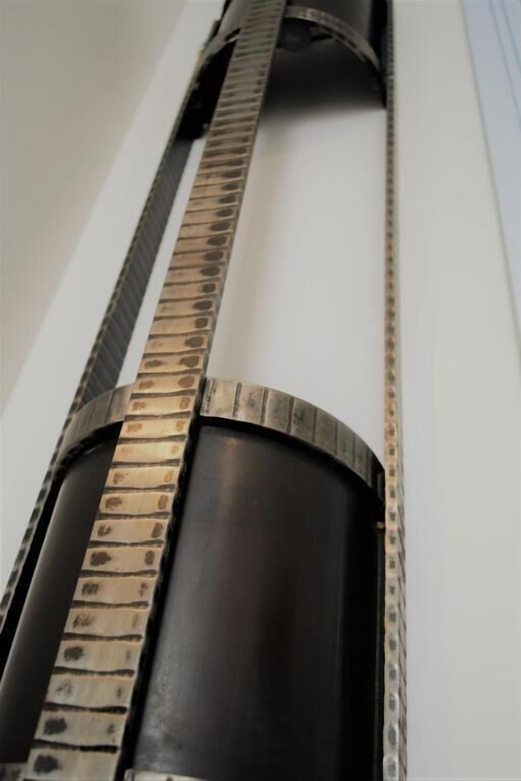 A close-up of a metallic structure with a curved design, possibly part of a building's exterior or interior architectural feature.