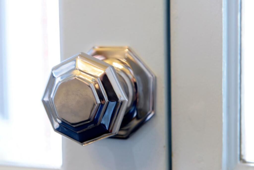 A hexagonal metallic door knob.
