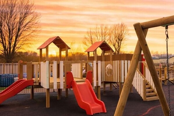 Un parque infantil con toboganes y columpios.