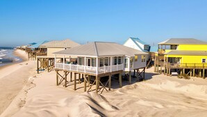 A beachside wooden structure with a balcony, elevated on stilts, overlooking the beach. - Simple Pleasures, Gulf Beachfront, 3 Bedroom, 2 Bath (Dauphin Island)