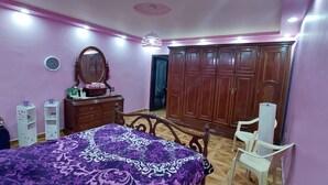 A bedroom with a bed, dresser, wardrobe, and a vanity with mirror. - Modern Duplex In the center of Irbid (Irbid)