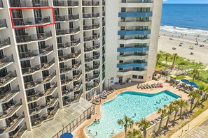 A high-rise hotel with multiple balconies, a pool area, and a beach view. - Ocean Reef Resort Unit 919 (Myrtle Beach)