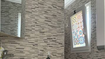 Shower, hair dryer, towels, toilet paper