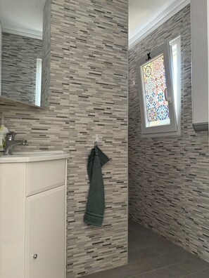 Shower, hair dryer, towels, toilet paper