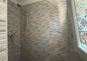 Shower, hair dryer, towels, toilet paper