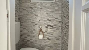 Shower, hair dryer, towels, toilet paper