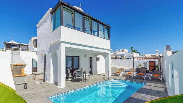 A modern villa with a rooftop pool, outdoor seating, and a covered patio area. - Villa Sol - Two Bedroom Villa, Sleeps 4 (Puerto del Carmen)