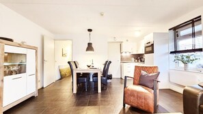 Cozy space with a dining table, comfortable seating area, and kitchenette.