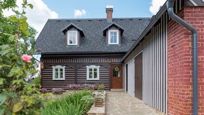 A two-story house with a stone pathway leading to the entrance. - Chalet in Liberec Near Ski Resort Jested (Svetla pod Jestedem)