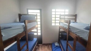 A narrow room with two bunk beds, each with a mattress and pillow, and a window providing natural light. - Holiday home, seasonal rental, guesthouse, ranch, Rosana Beach Resort (CDHU Velho Rosana)