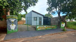 A gated property with a small building, a sign with wings, and a contact number. - Holiday home, seasonal rental, guesthouse, ranch, Rosana Beach Resort (CDHU Velho Rosana)