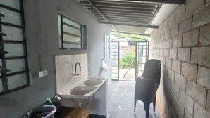 A narrow, enclosed bathroom with a sink and a window, leading to an outdoor area with a gate. - Holiday home, seasonal rental, guesthouse, ranch, Rosana Beach Resort (CDHU Velho Rosana)