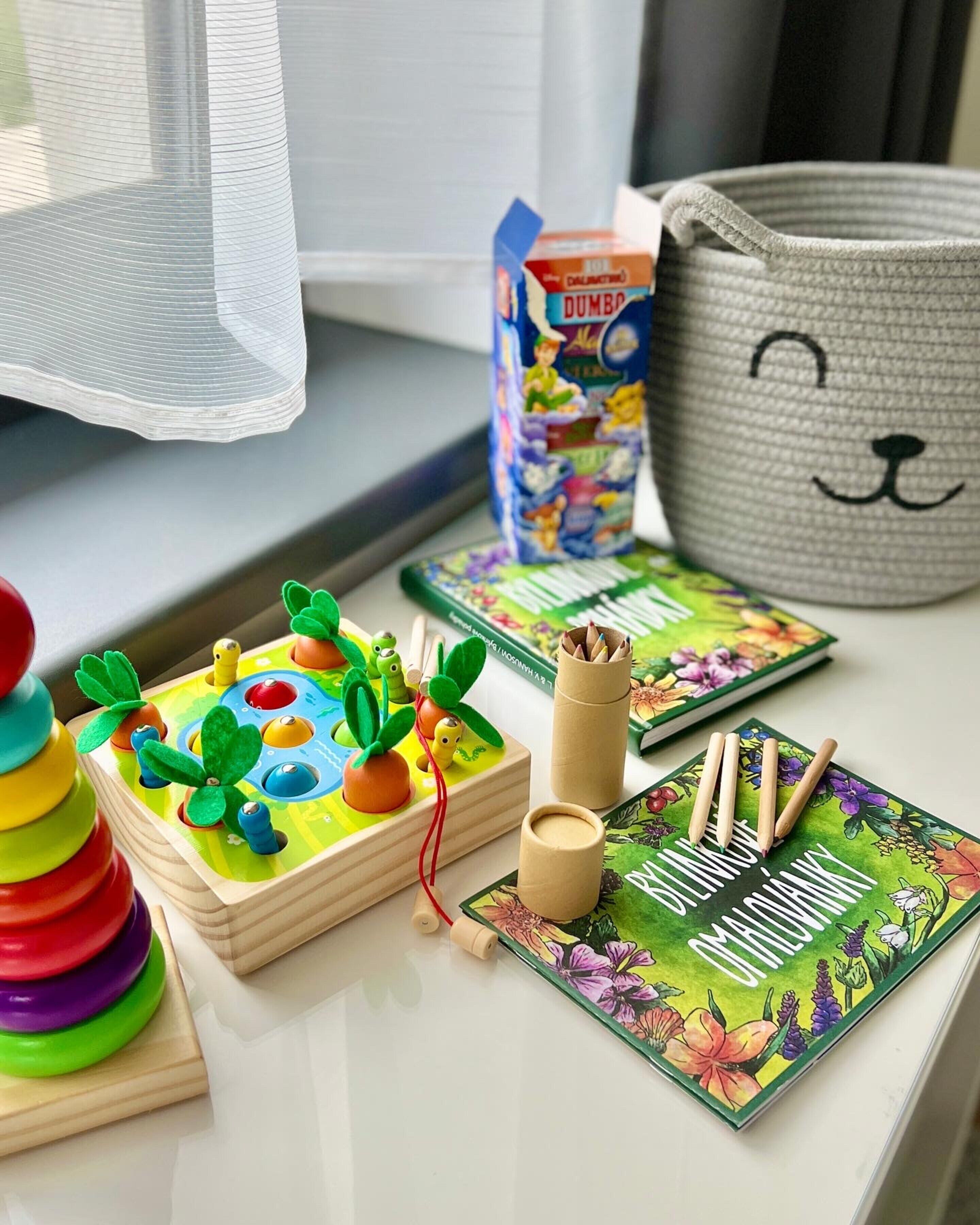 A table with educational toys, a book, and a basket.