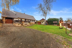 A residential property with a garage, a fenced yard, and a small wooden structure. - Villa in Dolni Branna Near Cross-country ski (Dolni Branna)
