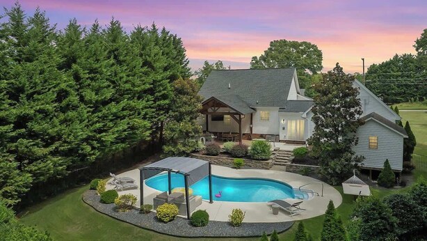 A house with a swimming pool, a covered patio, and a well-maintained lawn. - Luxury Retreat & Heated Pool Downtown Simpsonville (Simpsonville)