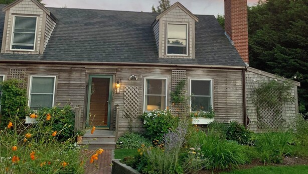 A two-story house with a gabled roof, a brick chimney, and a front porch with a lattice design. - Beautiful Nantucket summer escape,  3 bed house, quiet office, central location  (Nantucket)