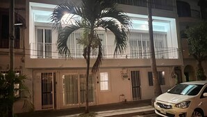 A two-story building with barred windows and a white facade. - Heart of Zona Romantica! 2BD/2Baths, 10 Sec. Walk Beach & Malecon! Quiet Street. (Puerto Vallarta)