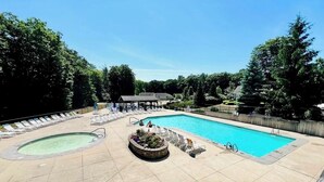 A swimming pool with lounge chairs and a covered area, surrounded by trees. - Cozy 2 BR house in gated community 1 mile from Wells/Ogunquit beaches/shops  (Wells)