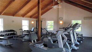 A gym with treadmills, dumbbells, and a ceiling fan. - Cozy 2 BR house in gated community 1 mile from Wells/Ogunquit beaches/shops  (Wells)