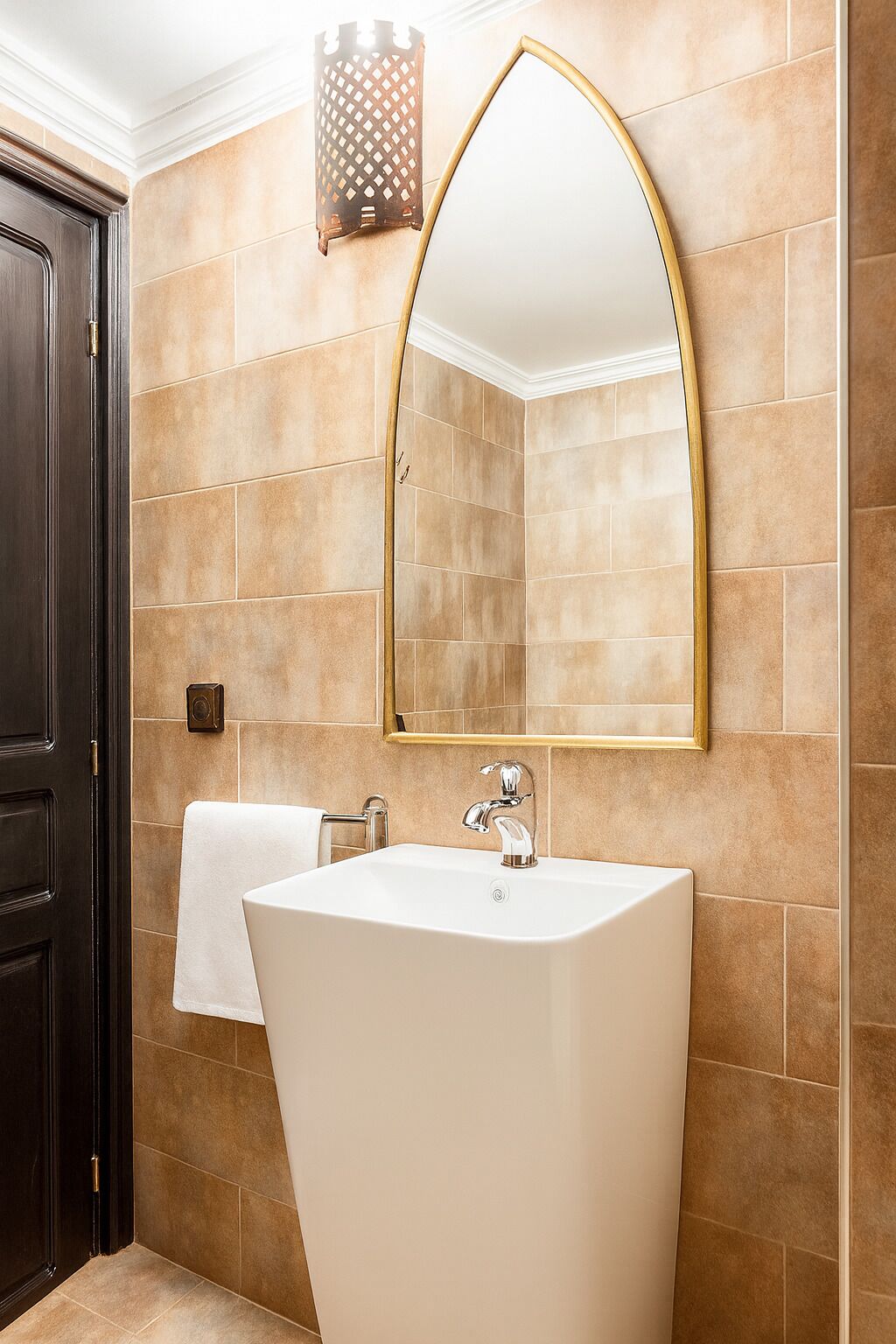 A bathroom with a freestanding bathtub, a wall-mounted mirror, and a towel rack.