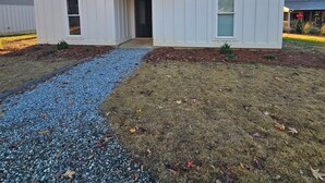 A two-story white house with a front porch, a gravel driveway, and a lawn with scattered leaves. - New lakefront 3 bedroom, 2 story house in lovely Georgetown with private dock (Georgetown)