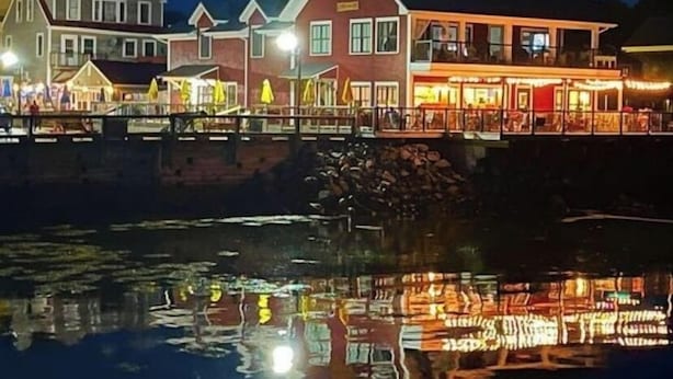 A waterfront building with multiple levels, featuring balconies and large windows. - Captain Dan's Sunset Suite (St. Andrews)