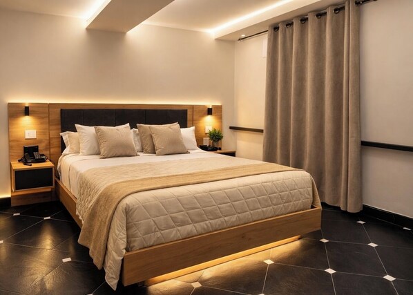 A modern hotel room with a large bed, bedside lamps, a wooden headboard, and a tiled floor.