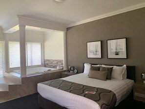 Premium bedding, desk, laptop workspace, iron/ironing board