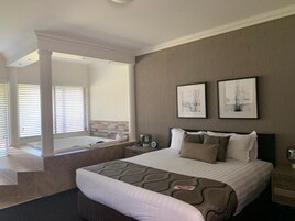 Premium bedding, desk, laptop workspace, iron/ironing board