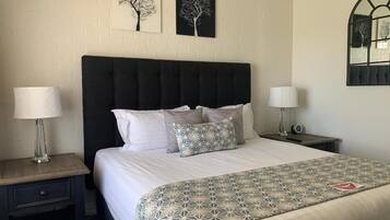 Premium bedding, desk, laptop workspace, iron/ironing board