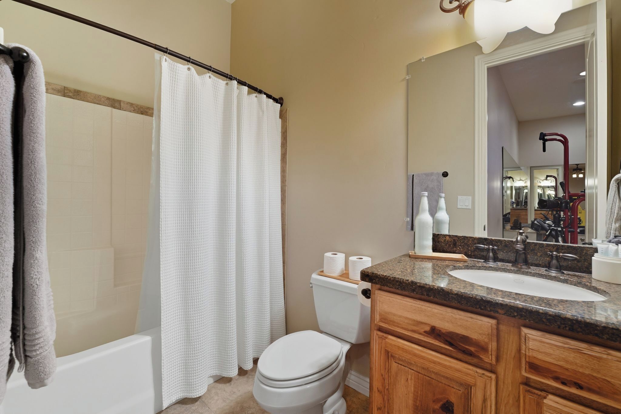 A bathroom with a bathtub, toilet, and sink.