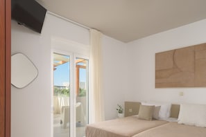 A bedroom with a bed, a TV, a sliding glass door to a balcony, and a large abstract painting on the wall.