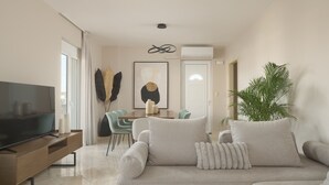 Un salon comprenant un téléviseur, un canapé et un coin repas.